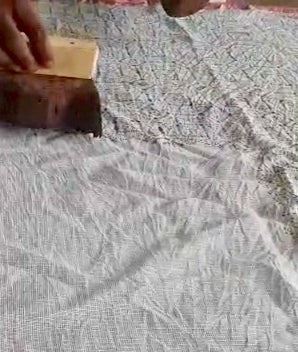 video showing art of hand block printing on fabric using mud as a resist.